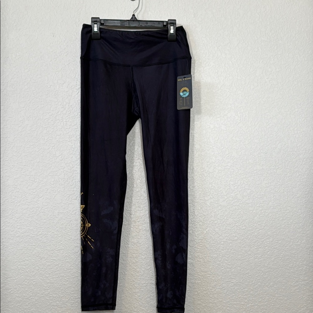 Sol & Mane medium Black Leggings with Gold graphic NWT
Sacred Cora Tri legging
